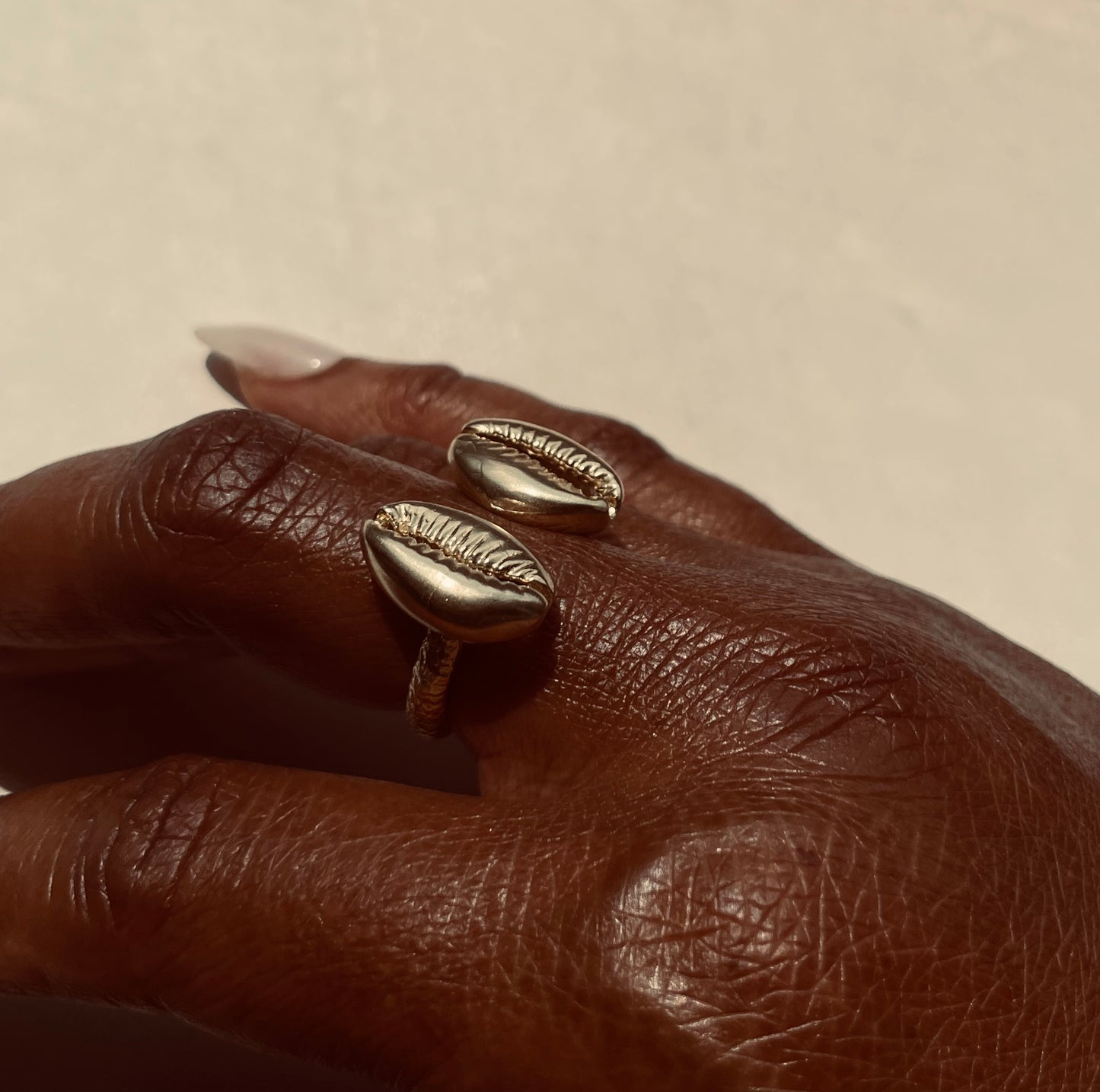 The Floating Cowrie Ring in gold & silver