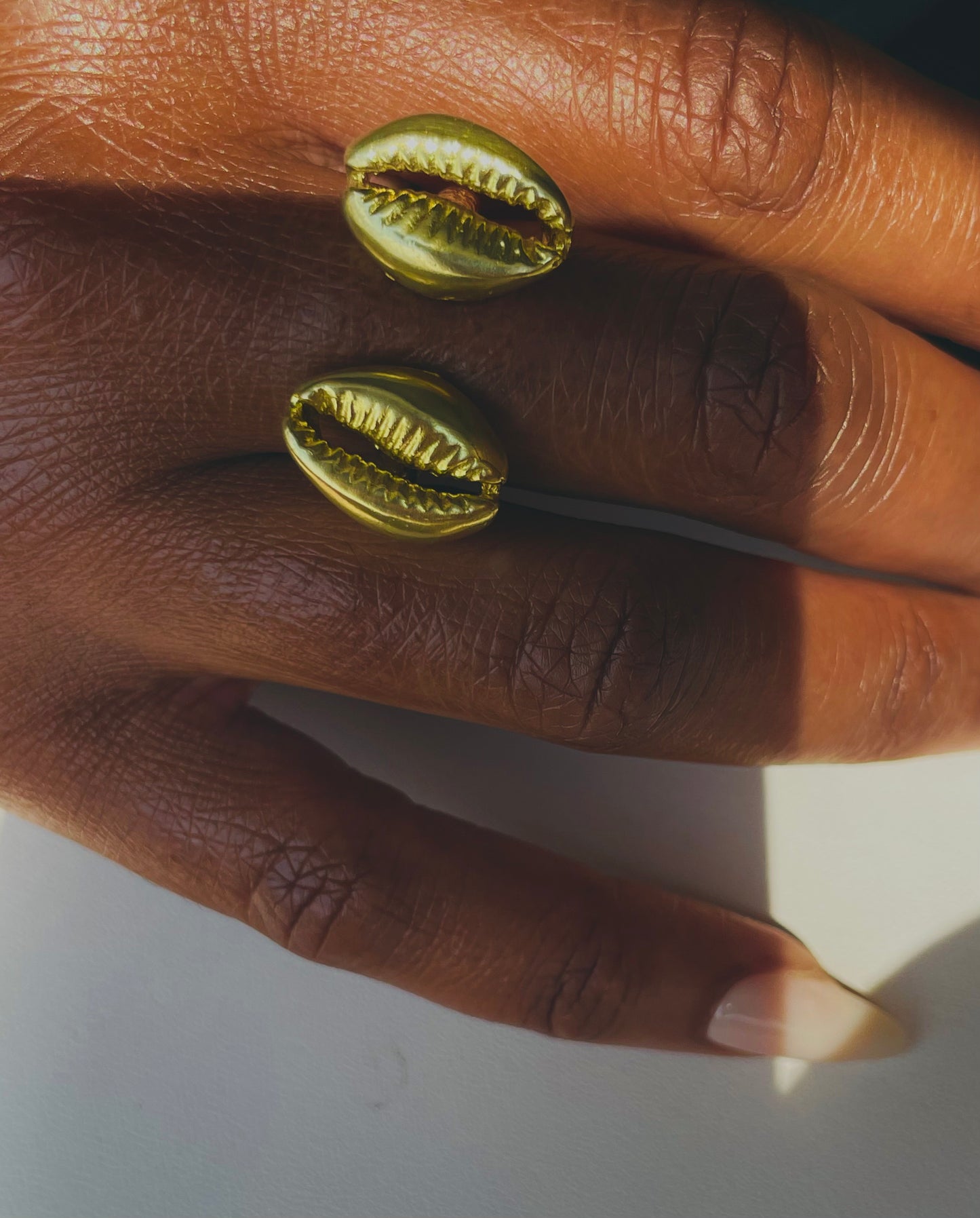 The Floating Cowrie Ring in gold & silver