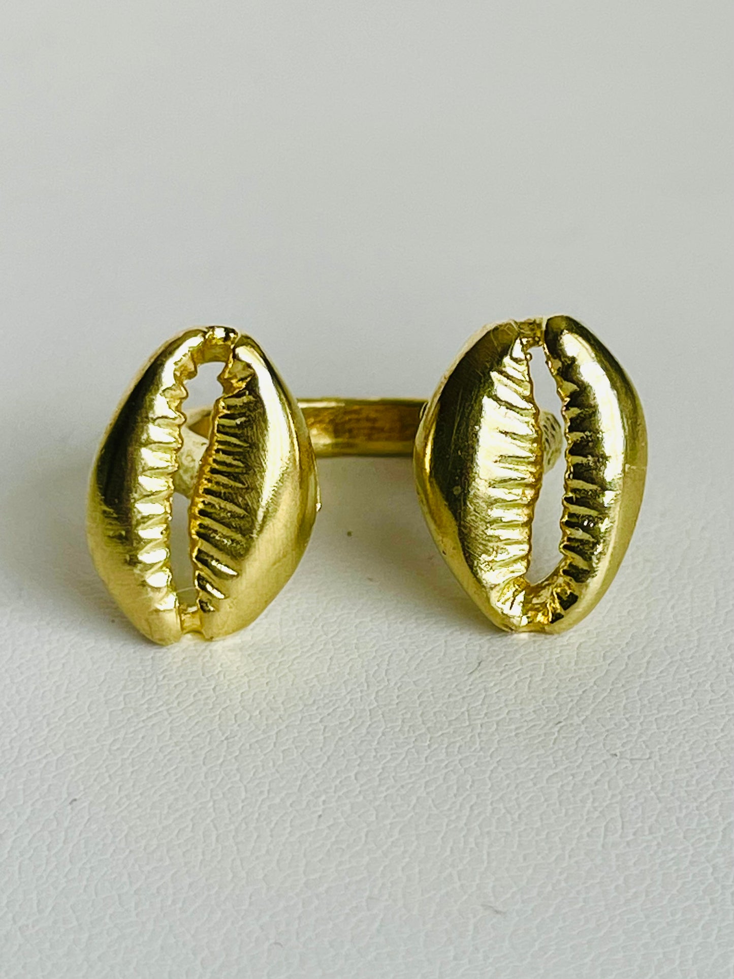 The Floating Cowrie Ring in gold & silver