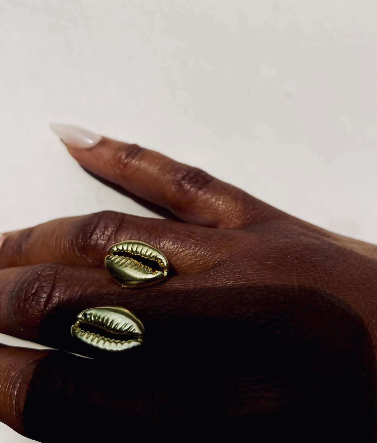 The Floating Cowrie Ring in gold & silver